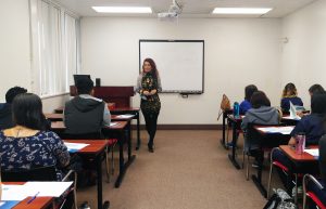 Dr. Marilyn Uvero, the AUHS Vice President of Operations and Development, greets incoming students for the Spring 2017 quarter.