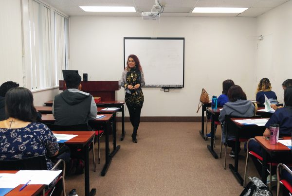 Dr. Marilyn Uvero, the AUHS Vice President of Operations and Development, greets incoming students for the Spring 2017 quarter.