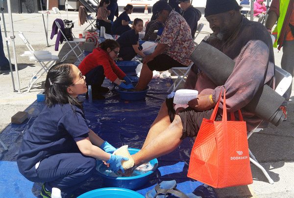 Robert Lee gets his feet washed by an AUHS student at the annual Lamp Unto My Feet event on Thursday, April 13, 2017.